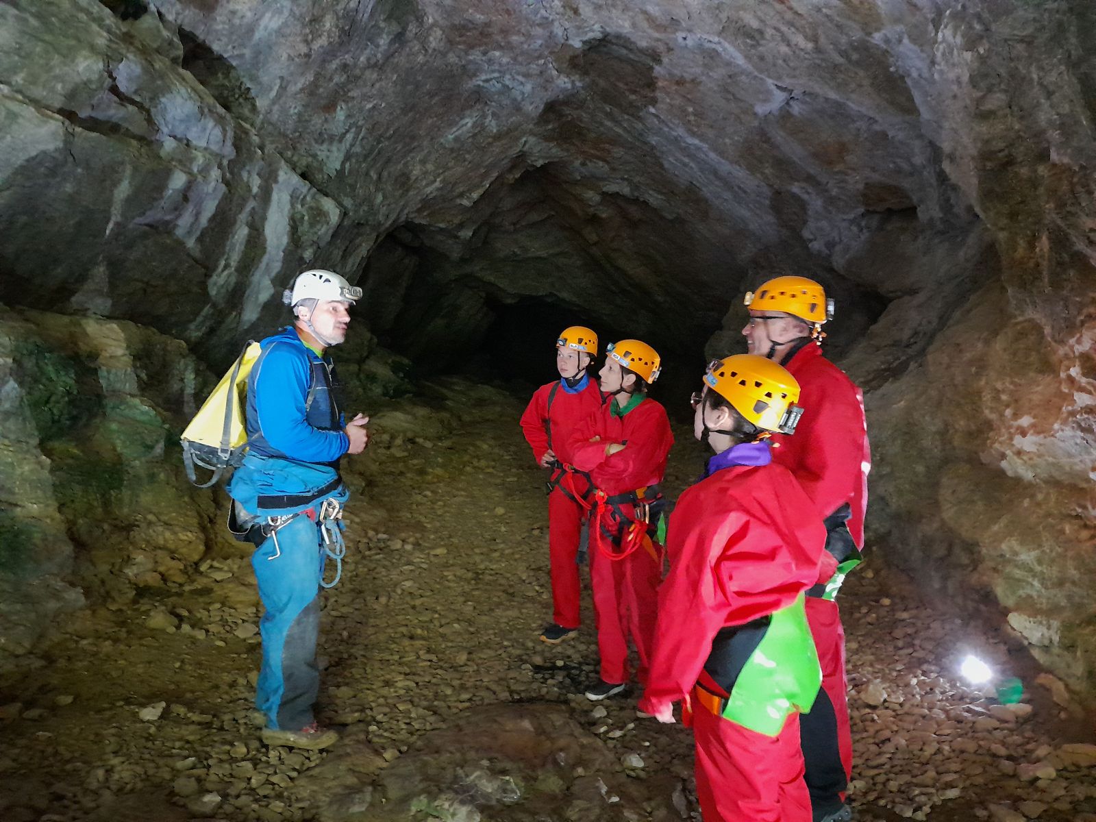 Groupe équipé avec un guide NOA Guides sous le porche d’entrée de la grotte des Faux-Monnayeurs