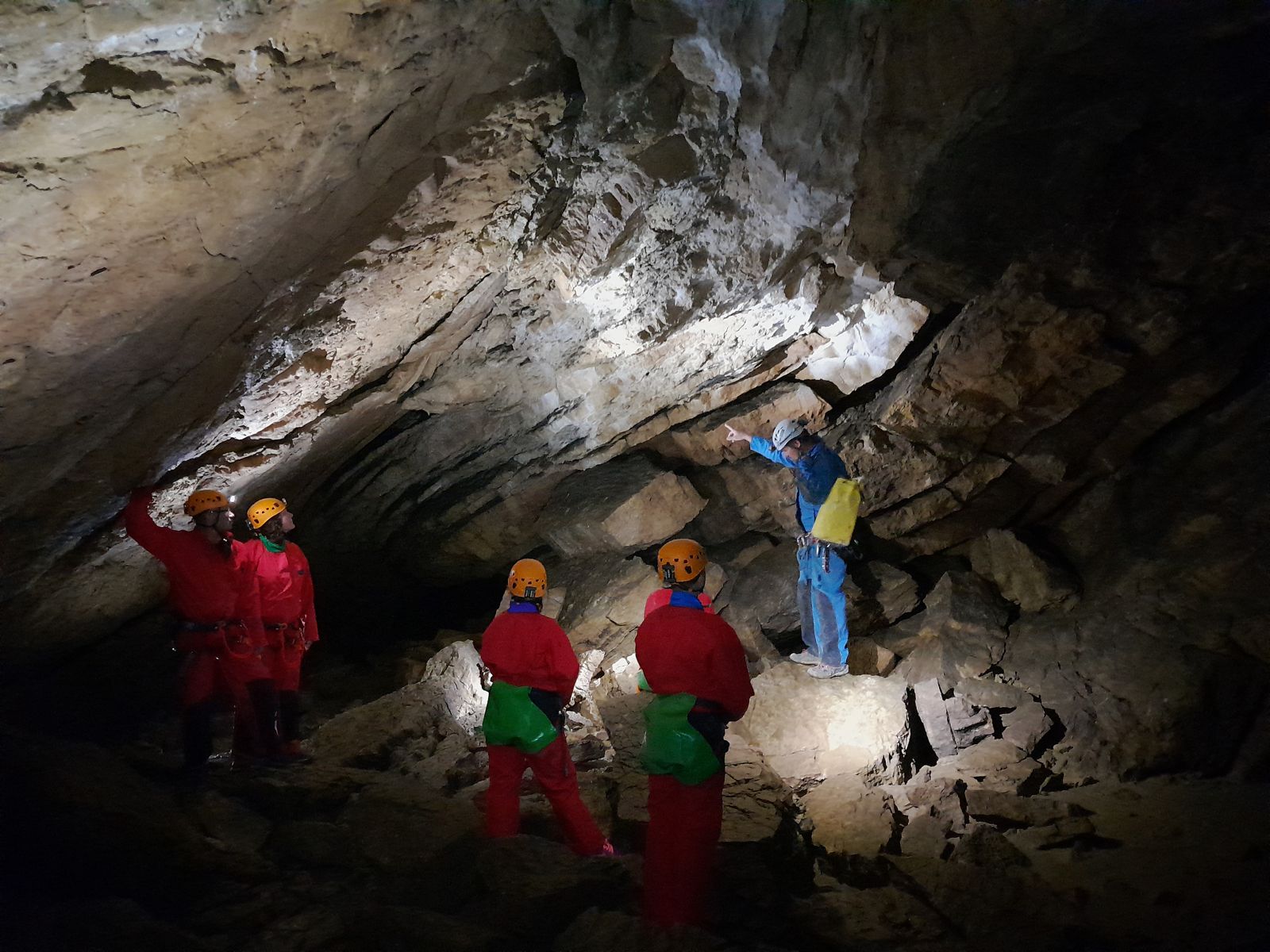 Groupe de spéléologues et leur guide dans une vaste galerie de la grotte des Faux-Monnayeurs
